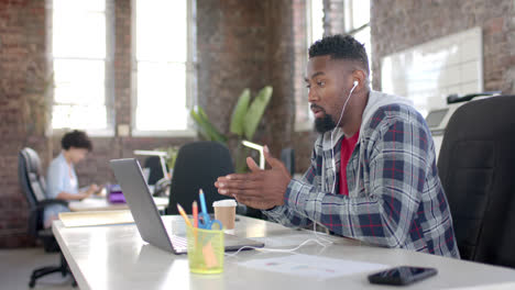 Focused-african-american-casual-businessman-having-laptop-video-call-in-office-in-slow-motion