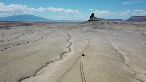 tracking aerial view of all terrain vehicle moving in utah desert usa