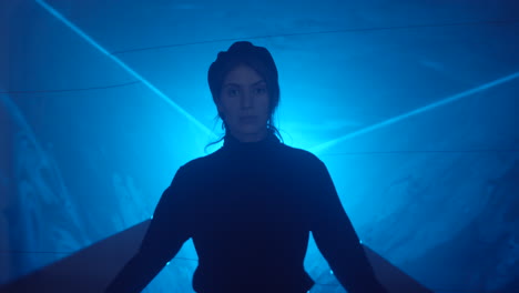 portrait of woman in studio with blue laser light