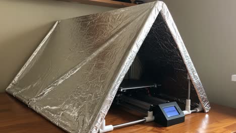 A Modern Foldable Tent with Reflective Material, Suitable for Indoor Use, Featuring a Compact Design and Technological Accessories for Convenience and Style