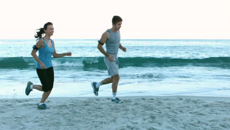 Sporty-people-running-on-the-beach