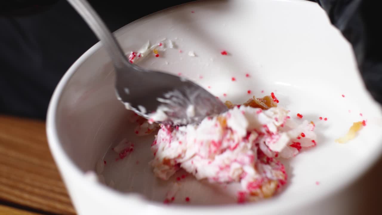Mixing dessert ingredients in a bowl with a spoon