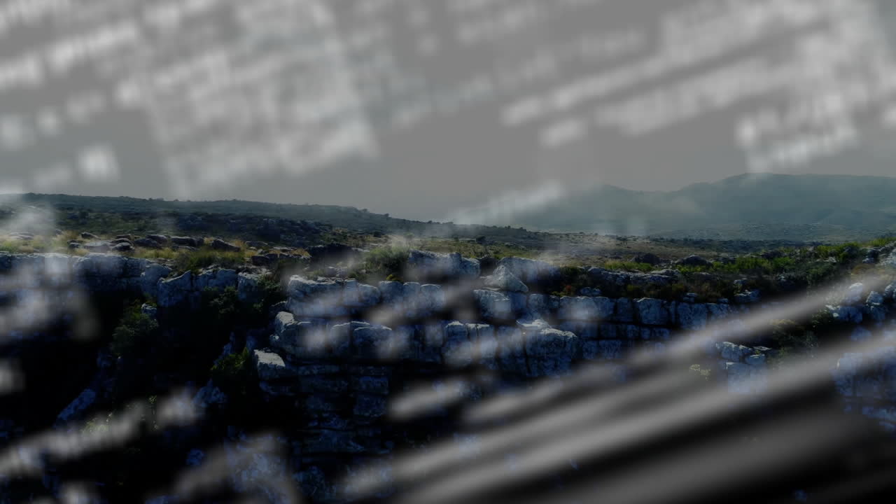 Animation of misty landscape with rocky terrain, blurred text overlaying scene