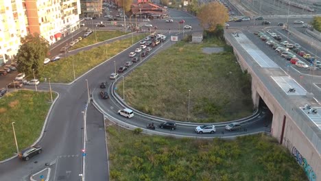 heavy traffic on a crossroad in golden hour, moving up drone