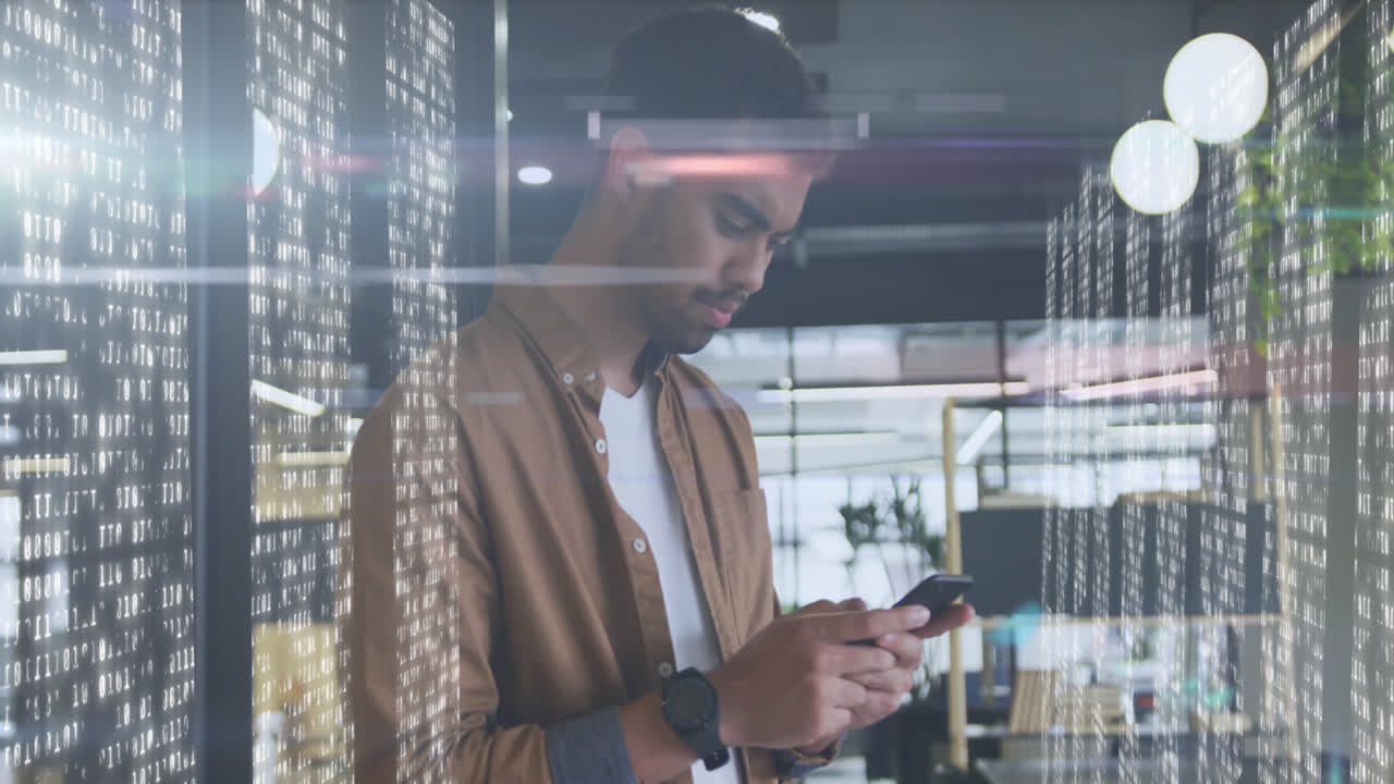 Animation of biracial businessman using smartphone over data processing