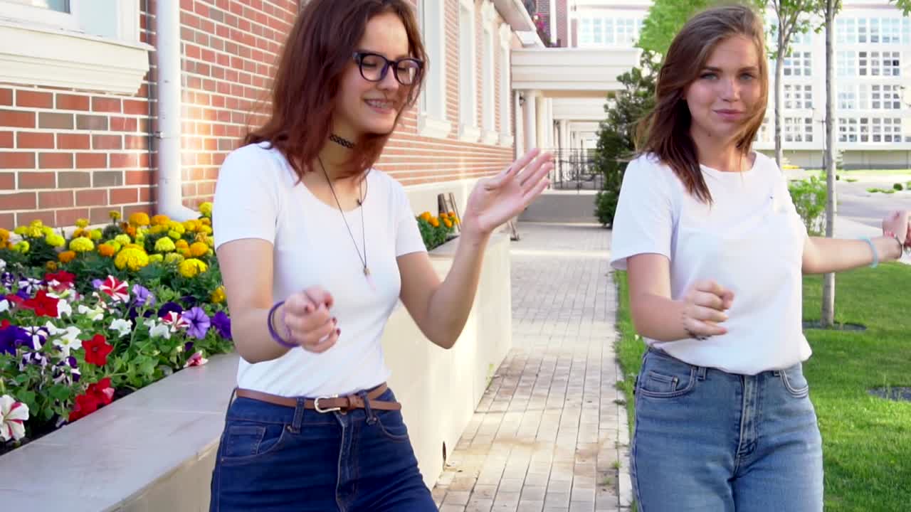 Two girls dancing and walking