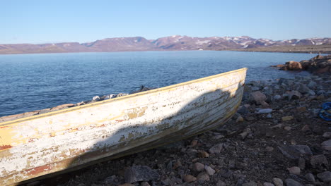 Rustic-Boat-on-Coast-of-Cape-Tobin,-Greenland-on-Sunny-Late-Spring-Day