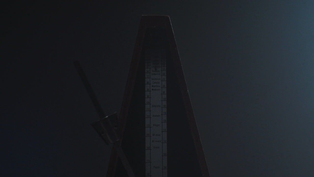 Metronome set the rythm in the dark, old room