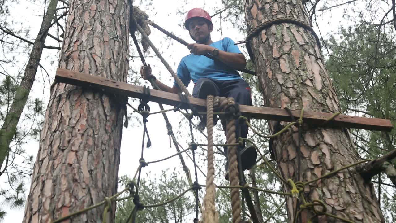 Burma bridge crossing by mountaineers of an Mountaineering training institute located in upper Himalayas, Uttarakhand, India.Himalayas mountaineers.