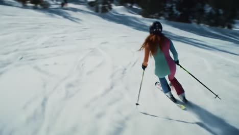 woman skiing down a snowy mountain slope