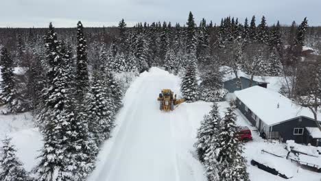 drone video captures the power and a snow plow in action as it clears snow in the winter wonderland of alaska