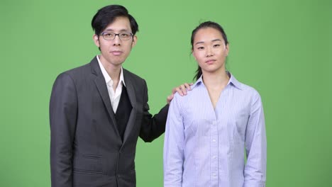 young happy asian business couple together