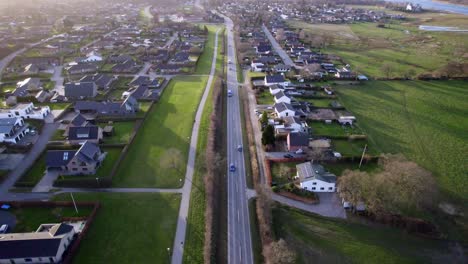 cars navigating a street in a small suburban danish city, showcasing urban life