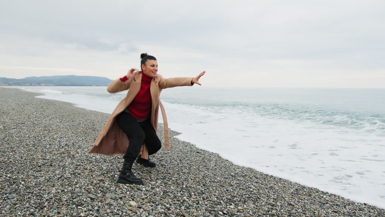 By The Sea A Carefree Woman Dances To Free Herself From Negative Thoughts