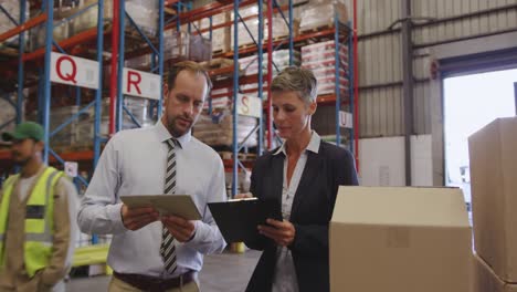 warehouse managers working together in loading bay 4k