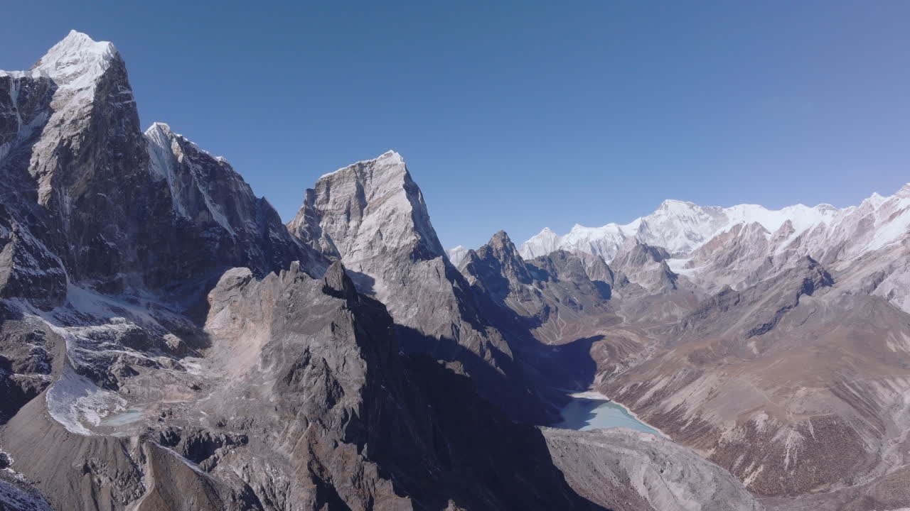 Aerial landscape of Nepal’s Khumbu Himalayas featuring Chola Tsho Lake in the Everest region. High-altitude mountain terrain with dramatic views toward towering 8000-meter Himalayan peaks