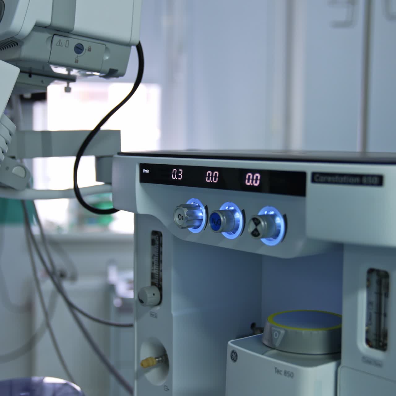 Hand of a doctor turning the handles on the medical equipment. Artificial lung ventilation system in modern operational room