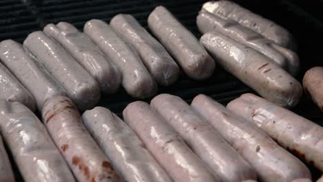 bbq cover raised revealing fresh pork sausages