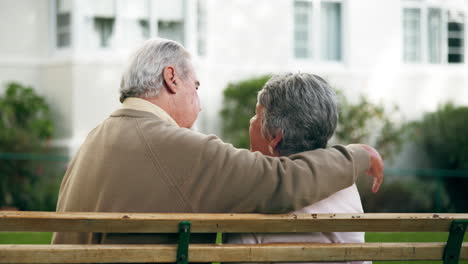 an elderly couple sharing a moment on a bench