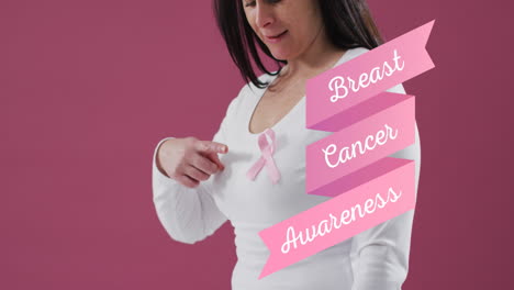 breast cancer awareness text banner against mid section of woman wearing pink ribbon on her chest