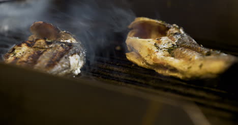 cook grilling fish in kitchen 6
