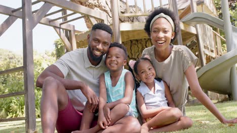 portrait of happy african american family in garden, in slow motion