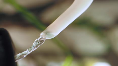 close-up of water flowing from a tube