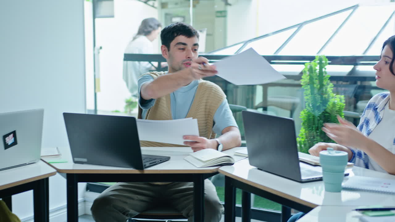 Young Coworkers Having Coffee Break and Chatting on Outdoor Terrace