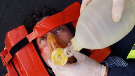 emergency medical technician placing an oxygen mask