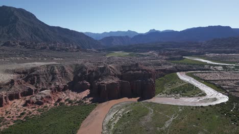 aerial drone above quebrada de cafayate and calchaqui valley, salta route contrasting mountain desert and vineyard subtropical forest, travel and tourism argentina