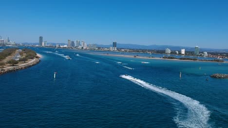 aerial view of a busy day on popular waterway with a city skyline in the distance