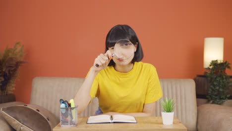 woman looking at camera with magnifying glass.