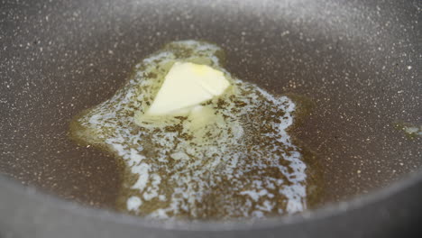 close up of melting butter in a pan
