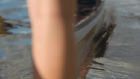 Slow-motion-shot-of-man-launching-kayak-into-water