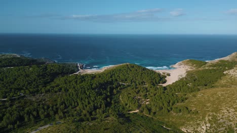 beautiful beach bay with green hills, clear turquoise sea water, white sand
