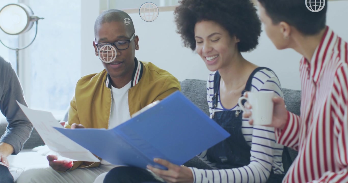 Animation of digital globe icons over diverse business people in office