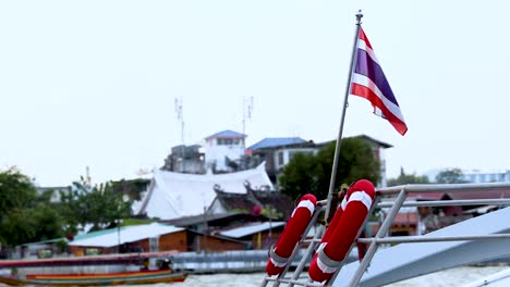 thai flag waving on a moving boat