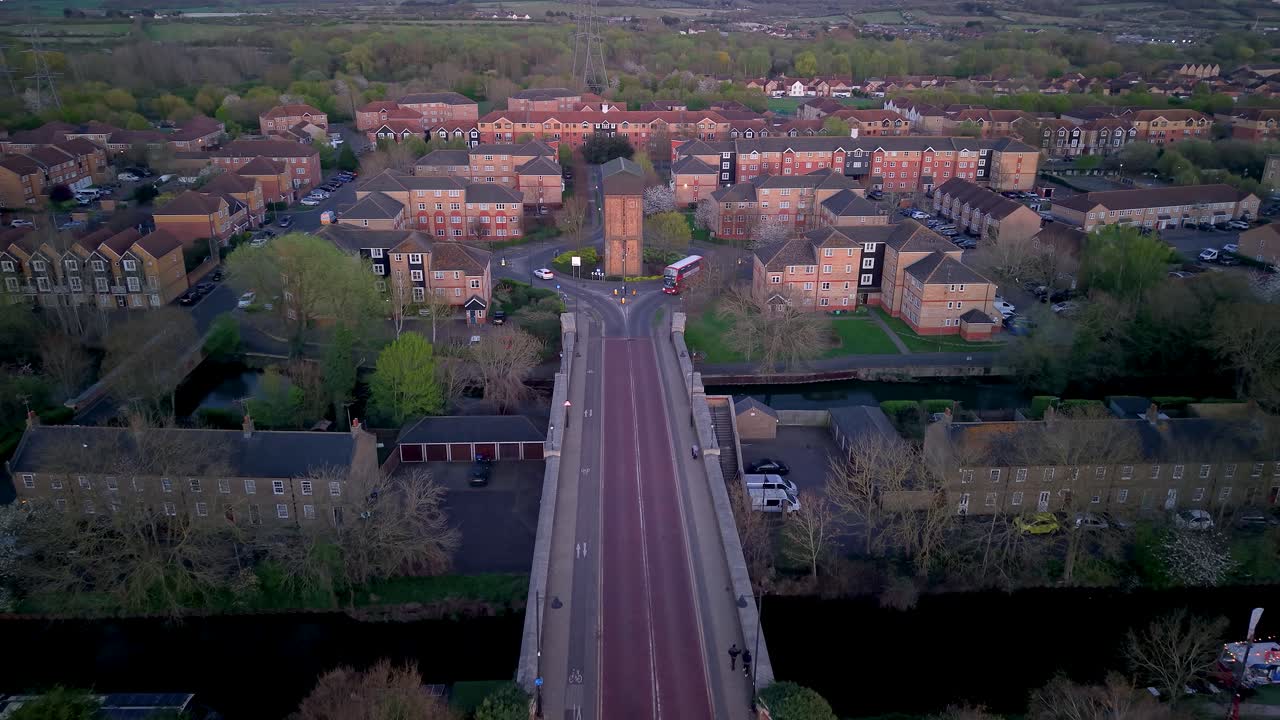 Enfield island water tank tower aerial view towards sunlit urban village roundabout near London city