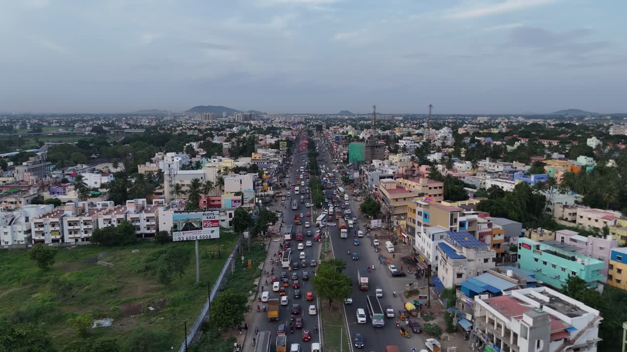 Aerial view of a bustling Chennai cityscape with high-rise buildings and busy streets