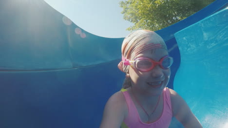 mom and daughter are going fun down the water slide laughing happy family on vacation