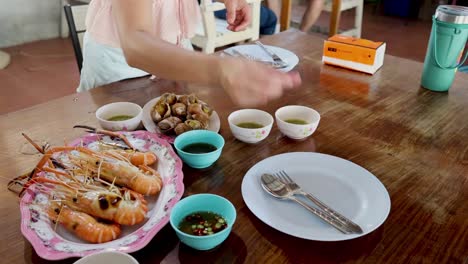 setting the table with plates and seafood dishes.