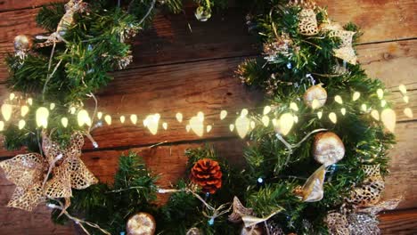 animation of string lights over decorated christmas wreath