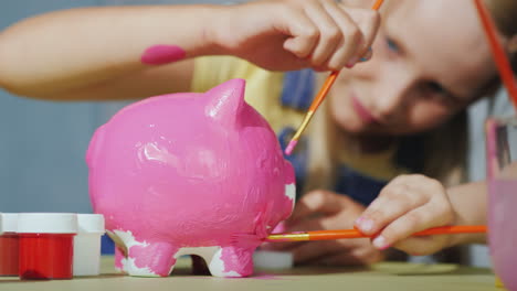 Children-Cheerfully-Paint-Piggy-Bank-Happy-Childhood-Concept-4K-Video