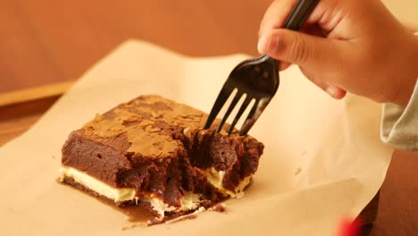 eating a delicious chocolate brownie
