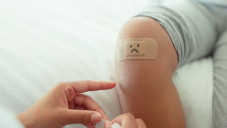 knee, bandage and parent with child in bedroom