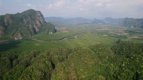 drone flying high over ao thalane mountains overlooking the river and mangroves on a sunny day in krabi thailand