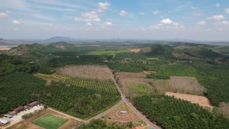 Aerial-drone-of-a-large-green-valley-in-the-rural-mountain-region-of-Krabi-Thailand-on-a-sunny-day