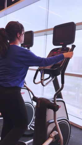 a woman is on a stationary bike in a gym