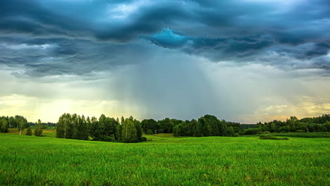 time-lapse of a dramatic sunset clouds and a rain shower moving over the countryside