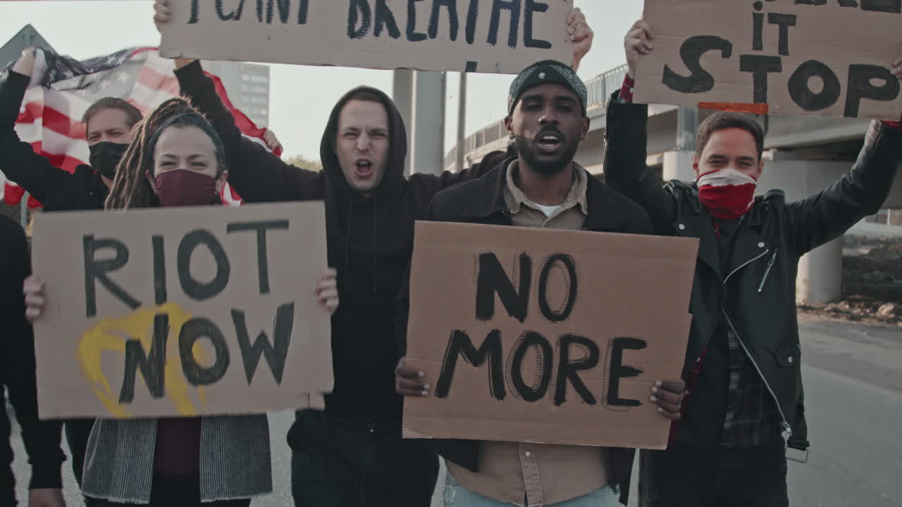 Protestors holding signs at a social justice rally